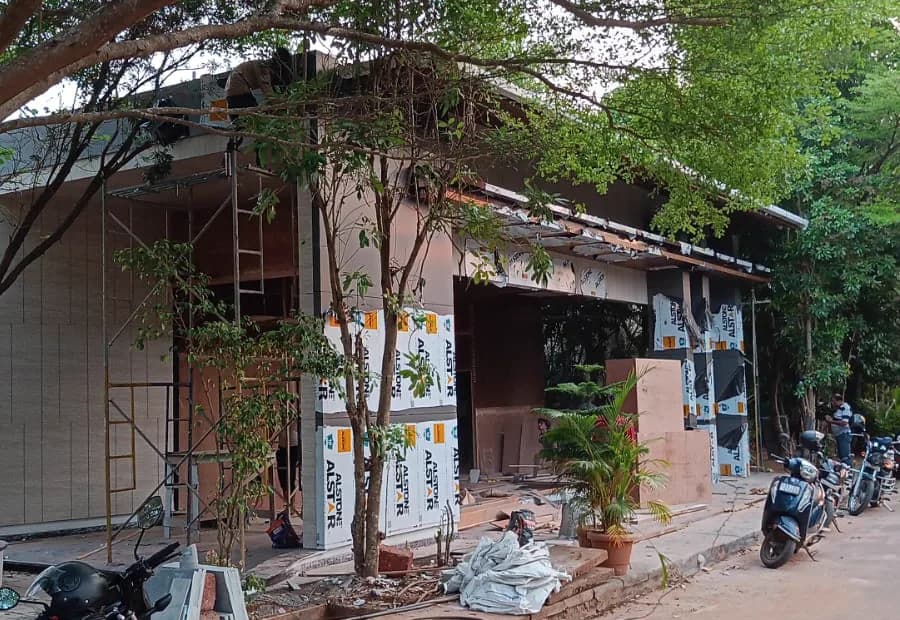A Homecraft project mid-construction: facade panels going up, scaffolding still standing and the entrance opening framed out.